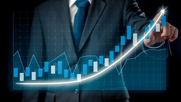 Businessman draw finance allusive graph chart showing business profit growth increasing to future target . Excellent financial status of corporate business rise up . Finance and money technology .