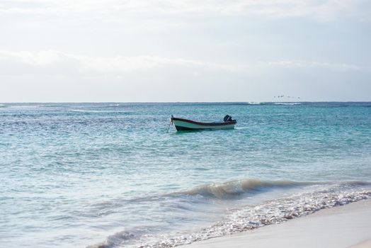 The boat in the Caribbean Sea on a sunny day. Clear water.