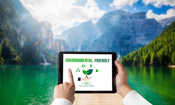 Green business transformation for environment saving and ESG business concept. Businessman using tablet to set corporate goal toward environmental friendly management and alternative clean energy use.