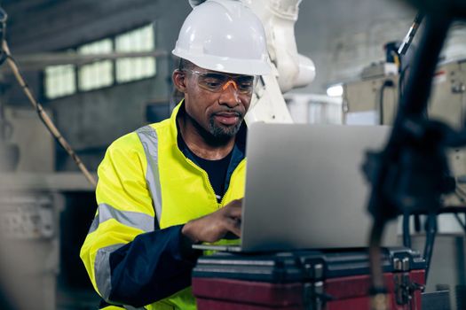 Factory worker working with laptop computer to do adept procedure checklist . Factory production line operator occupation quality control concept .