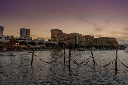 Hammocks hang on poles in the Caribbean.