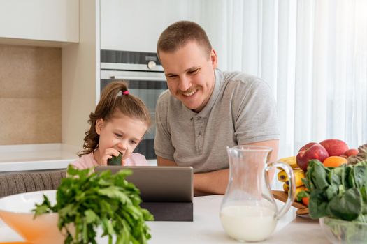 Loving Father Using Digital Tablet With Cute Little Girl