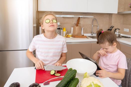 Cropped shot of girl cutting cucumber with knife