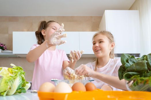 happy family funny kids are preparing the dough, bake cookies in the kitchen