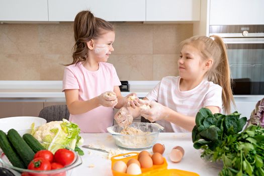 happy family funny kids are preparing the dough, bake cookies in the kitchen