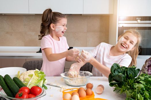 happy family funny kids are preparing the dough, bake cookies in the kitchen