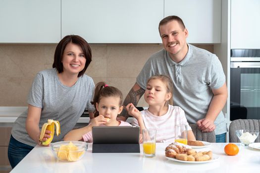 Smiling Family Dining Together at kitchen table