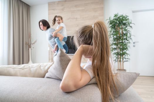 A little girl sitting on a couch. High quality photo