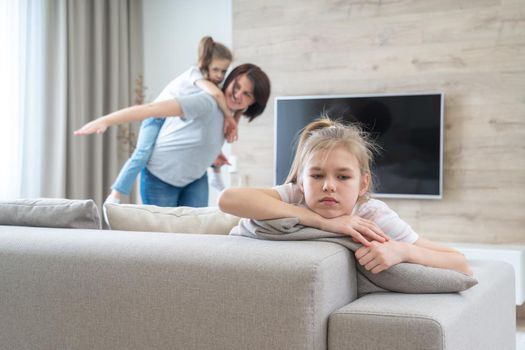 A little girl sitting on a couch. High quality photo