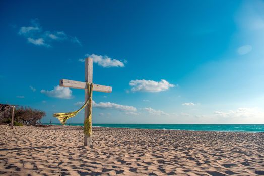 Wooden cross on the beach.