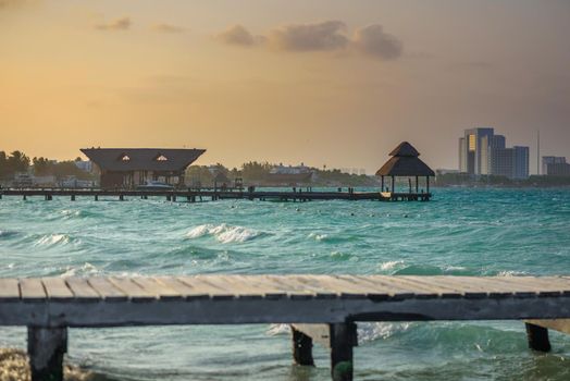 Pier on a beautiful sunset sun, with an azure sea. Wooden walkway