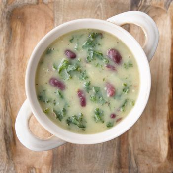 Portuguese Caldo Verde soup flat lay, square social media format.