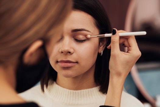 Close Up Female Make Up Artist in Protection Mask Working with Client Eyelid, Young Woman at Procedure in Beauty Salon