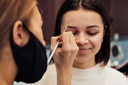 Close Up Female Make Up Artist Working with Client Eyebrows, Young Woman in Beauty Salon with Brow Master