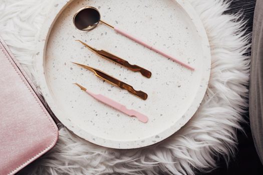 Flat Lay of Eyelashes Golden Tools Laid Up on Stone Tray