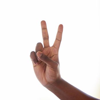 Studio shot of an unrecognisable man making a peace sign against a white background.