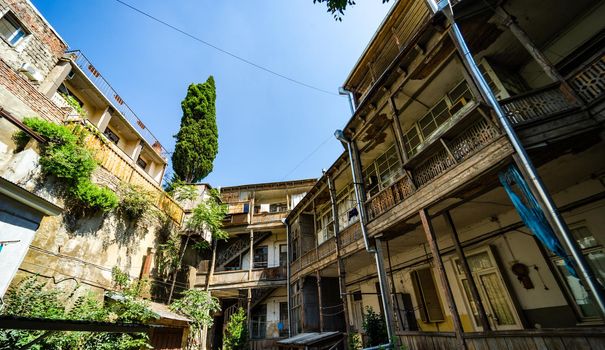 Traditional Tbilisi's inner yard with wooden carving balconies in the heart of Old town of Tbilisi, Georgia