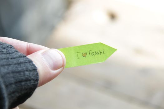 I love to travel concept. A man holds a pointer with an inscription. High quality photo