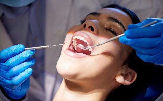 a young woman having a dental procedure performed on her.