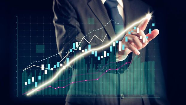 Businessman draw finance allusive graph chart showing business profit growth increasing to future target . Excellent financial status of corporate business rise up . Finance and money technology .