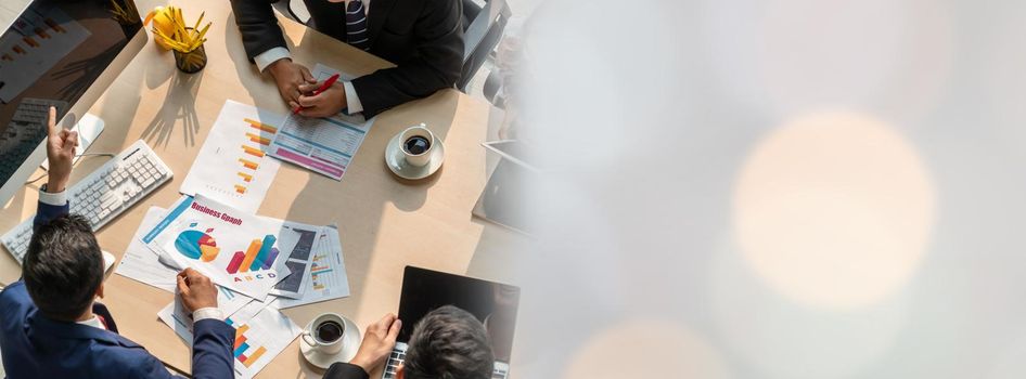 Business people group meeting shot from top widen view in office . Profession businesswomen, businessmen and office workers working in team conference with project planning document on meeting table .