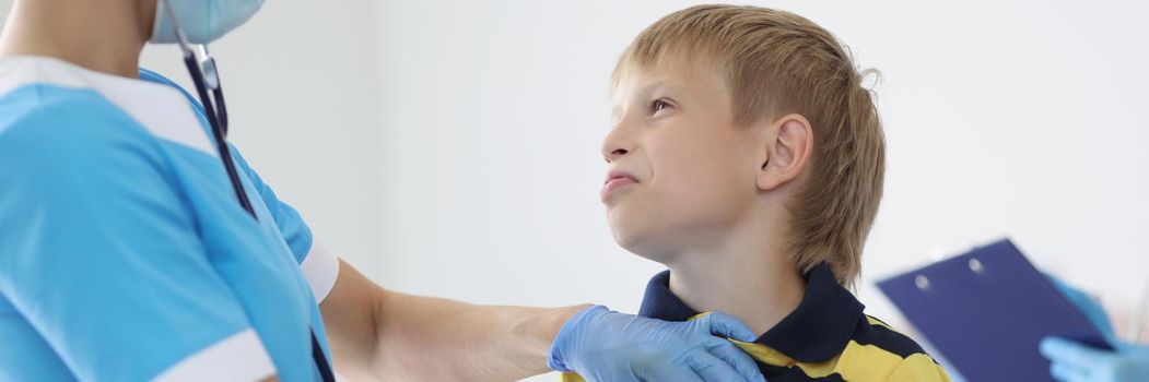 Portrait of female pediatrician listening to boy kid breathing with stethoscope tool, appointment at doctor. Checkup, clinic, healthcare, childhood concept