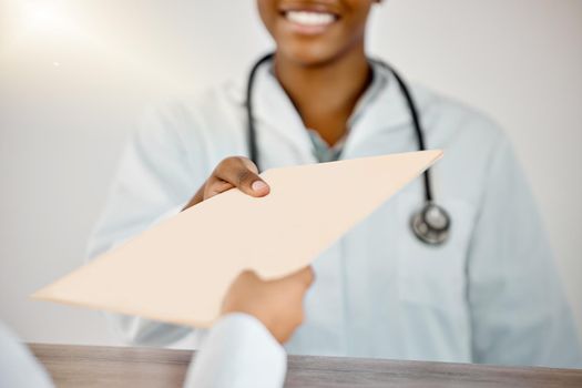 a young doctor and patient going through paperwork at a clinic.