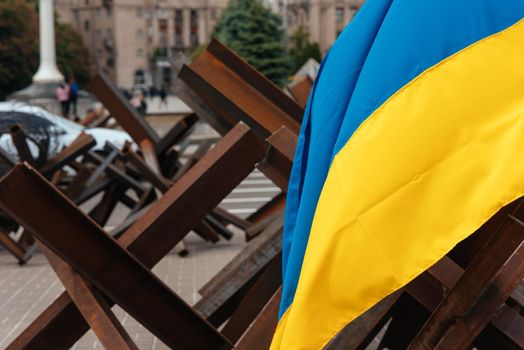 The Ukrainian flag hangs on barricades on the street