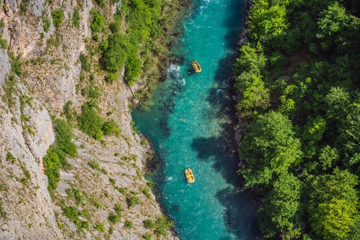 Famous rafting and kayaking place. Active kayakers in colorful life jacket paddling and exercising. Rafting on the turquoise river. Montenegro natural landscape, mountain river Tara.