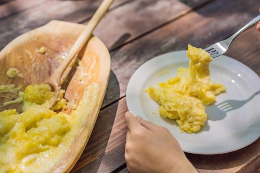 Traditional Montenegrin Meal. Kacamak in wooden bowl in the outdoor cafe.