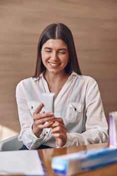 Happy beautiful caucasian woman with toothpaste in modern clinic's reception