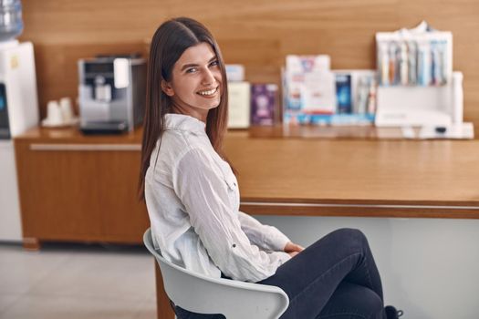 Portrait of happy caucasian smiling woman in dentist clinic's reception