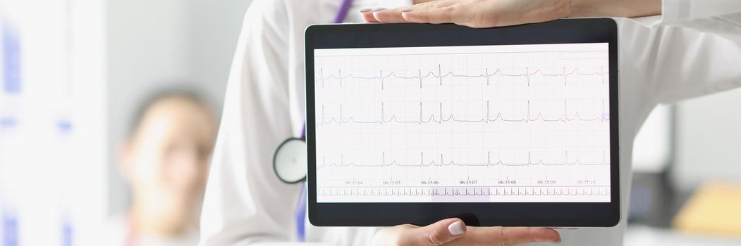 Close-up of doctor showing digital tablet screen with heart cardiogram result. Examination of cardiovascular system. Medicine, cardiology, health concept