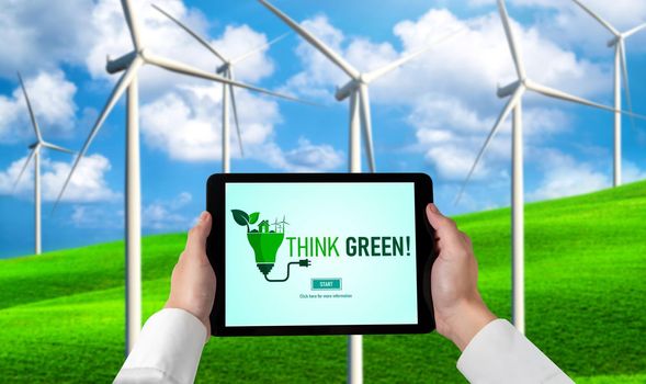 Green business transformation for environment saving and ESG business concept. Businessman using tablet to set corporate goal toward environmental friendly management and alternative clean energy use.