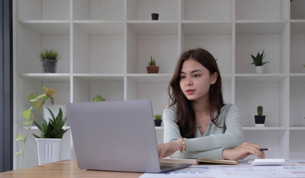 Portrait of smiling beautiful business asian woman working in modern office desk using tablet laptop computer, Business people employee freelance online marketing e-commerce telemarketing concept..