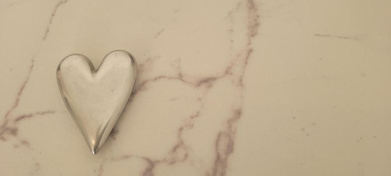 romantic background of iron shiny heart with marble and leaf