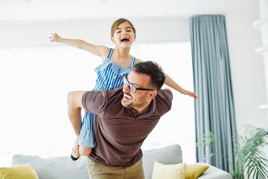 Family father and daughter having fun playing at home