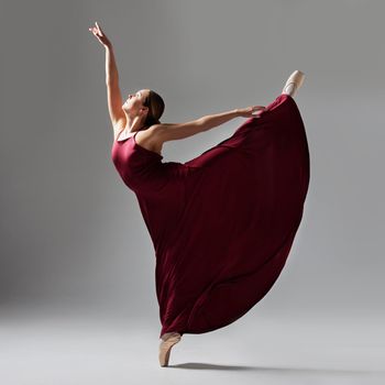 Full of a beautiful young ballet dancer rehearsing in a dance studio.