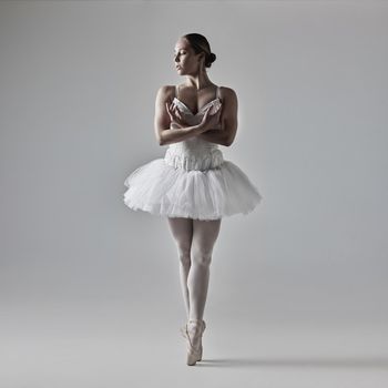 Full of a beautiful young ballet dancer rehearsing in a dance studio.