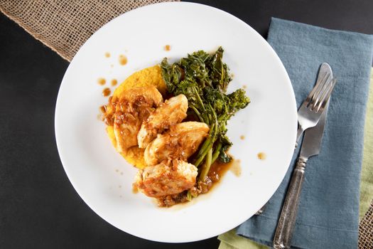 Chicken breast medallions with shallot marsala gravy, polenta and broccoli rabe