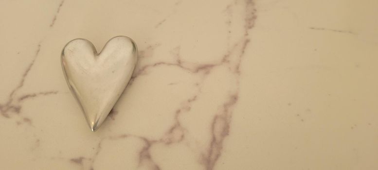 romantic background of iron shiny heart with marble and leaf