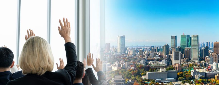 Group of business people meeting in a seminar conference widen view . Audience listening to instructor in employee education training session . Office worker community summit forum with speaker .