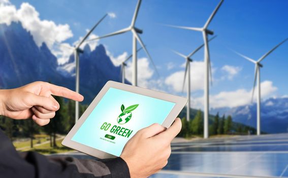 Green business transformation for environment saving and ESG business concept. Businessman using tablet to set corporate goal toward environmental friendly management and alternative clean energy use.