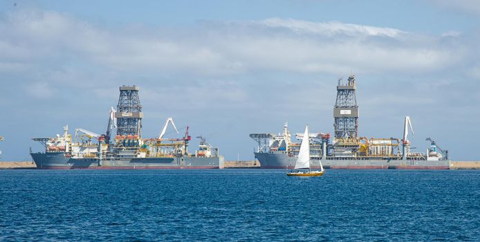 Picture of Las palmas Canary Island port with large ships carrying cargo, large container cranes and passenger ships