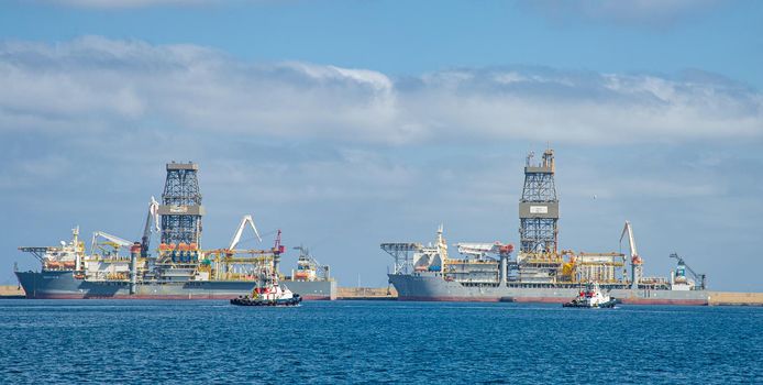 Picture of Las palmas Canary Island port with large ships carrying cargo, large container cranes and passenger ships