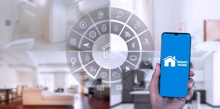 Man hand show smartphone smarth home GUI control every room in house. Hand use smart screen smart home automation assistant on a virtual screen and a user touching a button