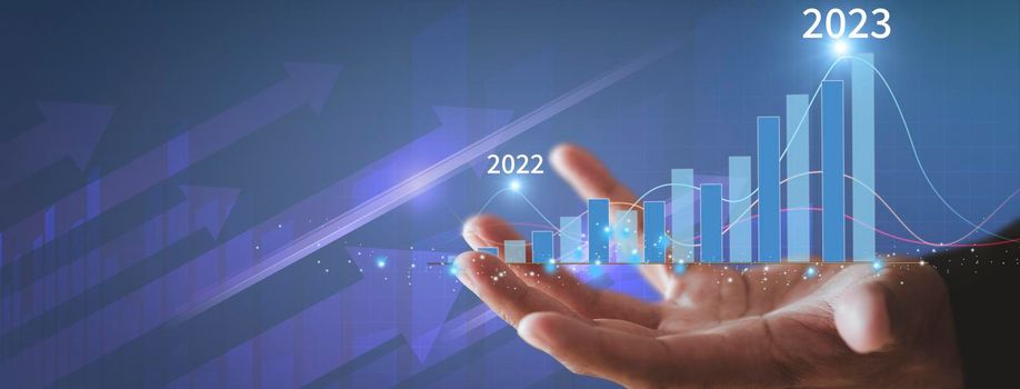 Businessman show golden stock market bar chart grow up to target. Business finance concept. Businessman's hands Show success graph, stocks grow every year With copy space banner