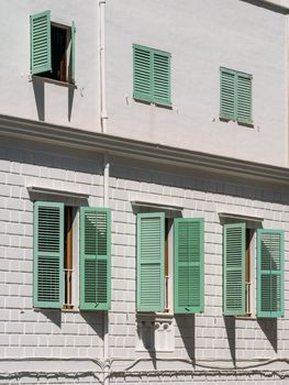 Wooden light green shutters and windows of a typical white house on the island of Ibiza, Spain. Vertical shot.