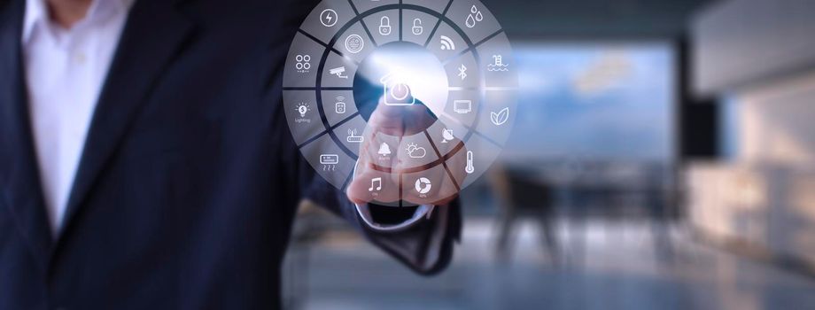 Man hand point smarth home GUI in livingroom. Hand use smart screen smart home automation assistant on a virtual screen and a user touching a button