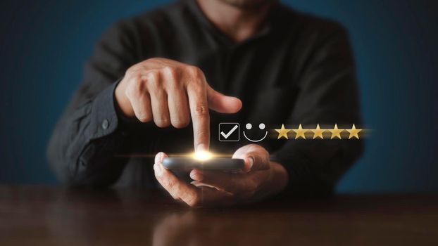 Businessman touching the virtual screen check mark joyful Smile face icon to give happiness in service. Customer service and satisfaction concept. Very impressed with the rating.